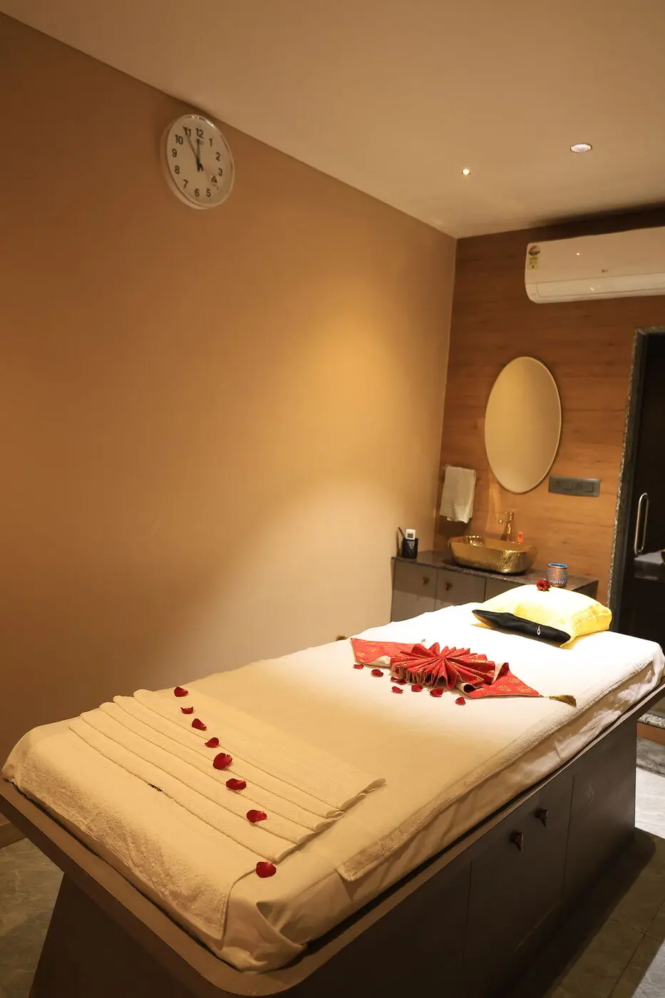 Private massage treatment room with wash basin and mirror