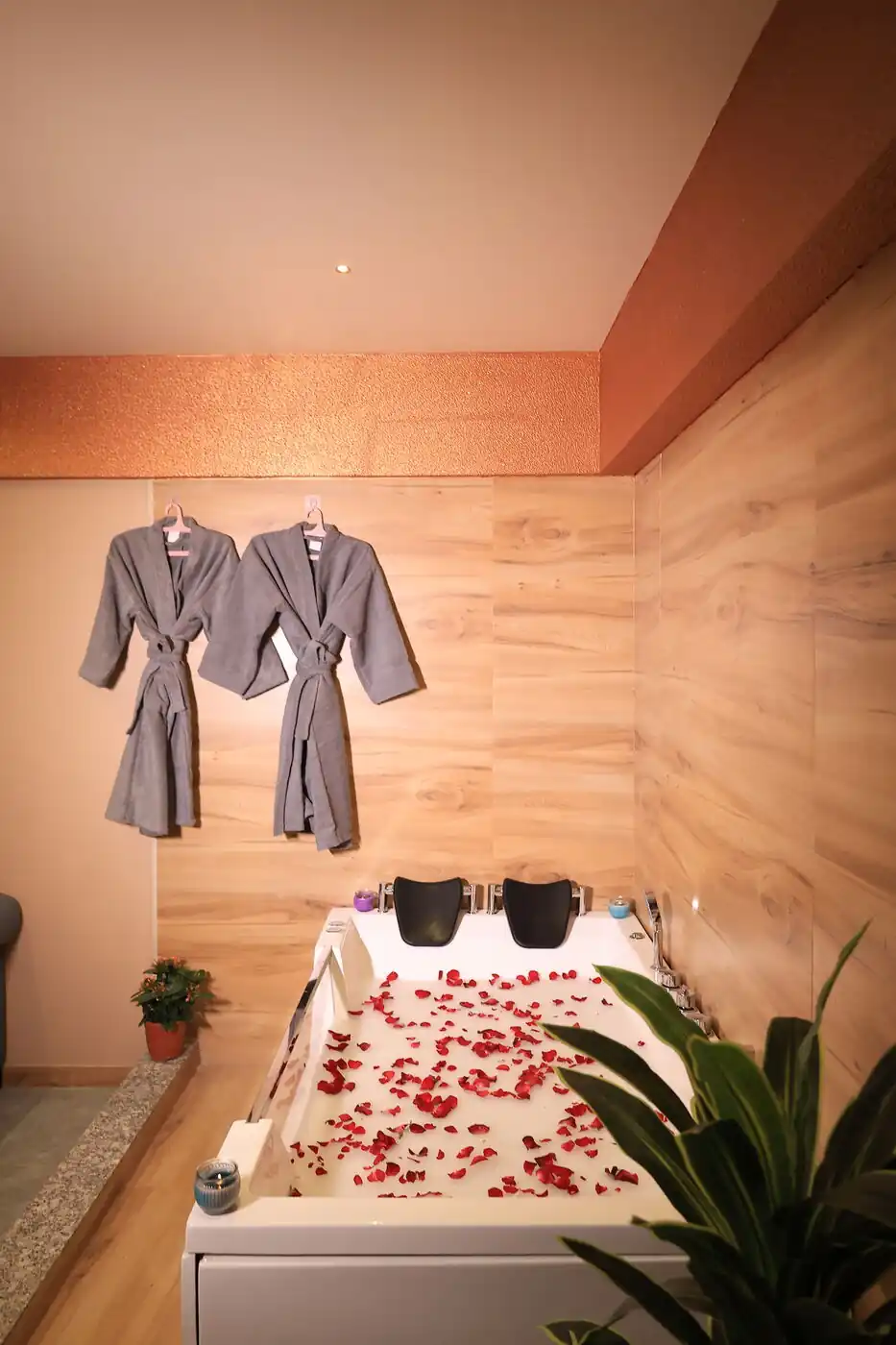 Jacuzzi bathtub with bathrobes in private spa suite