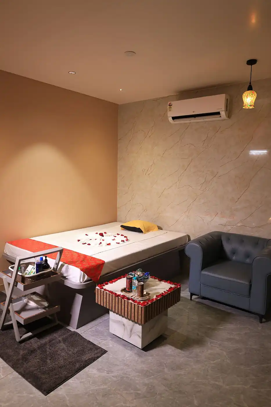 Single massage room with sofa and refreshment table