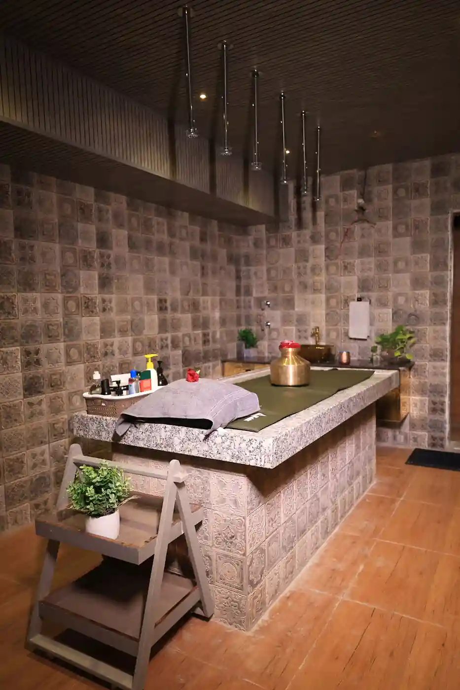 Moroccan bath and body scrub table in tiled hammam room